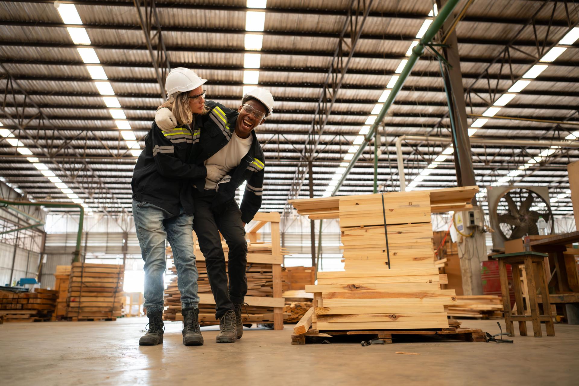 Lumber warehouse worker injured in leg, Colleagues help and support to go to the first aid room for treatment.